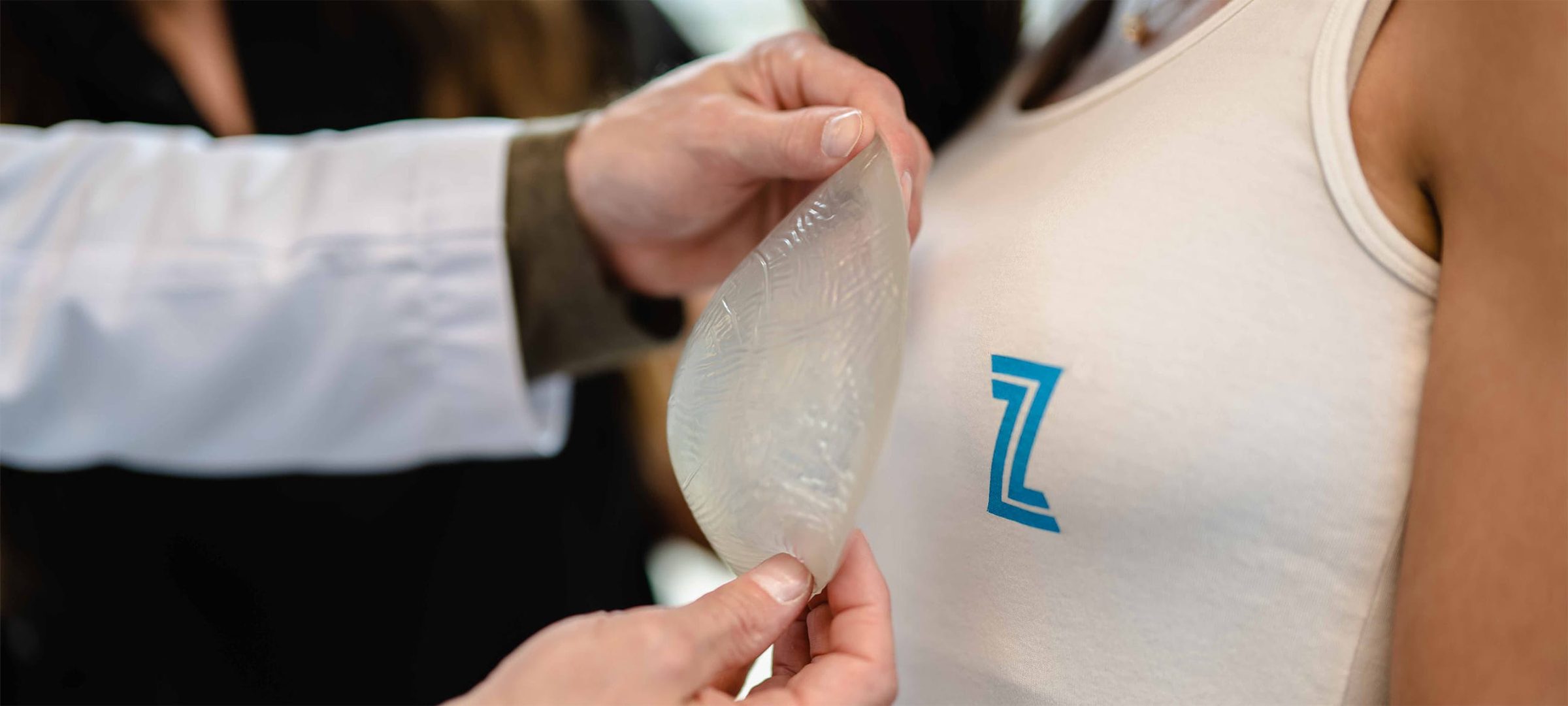 Woman testing out breast implant sizes