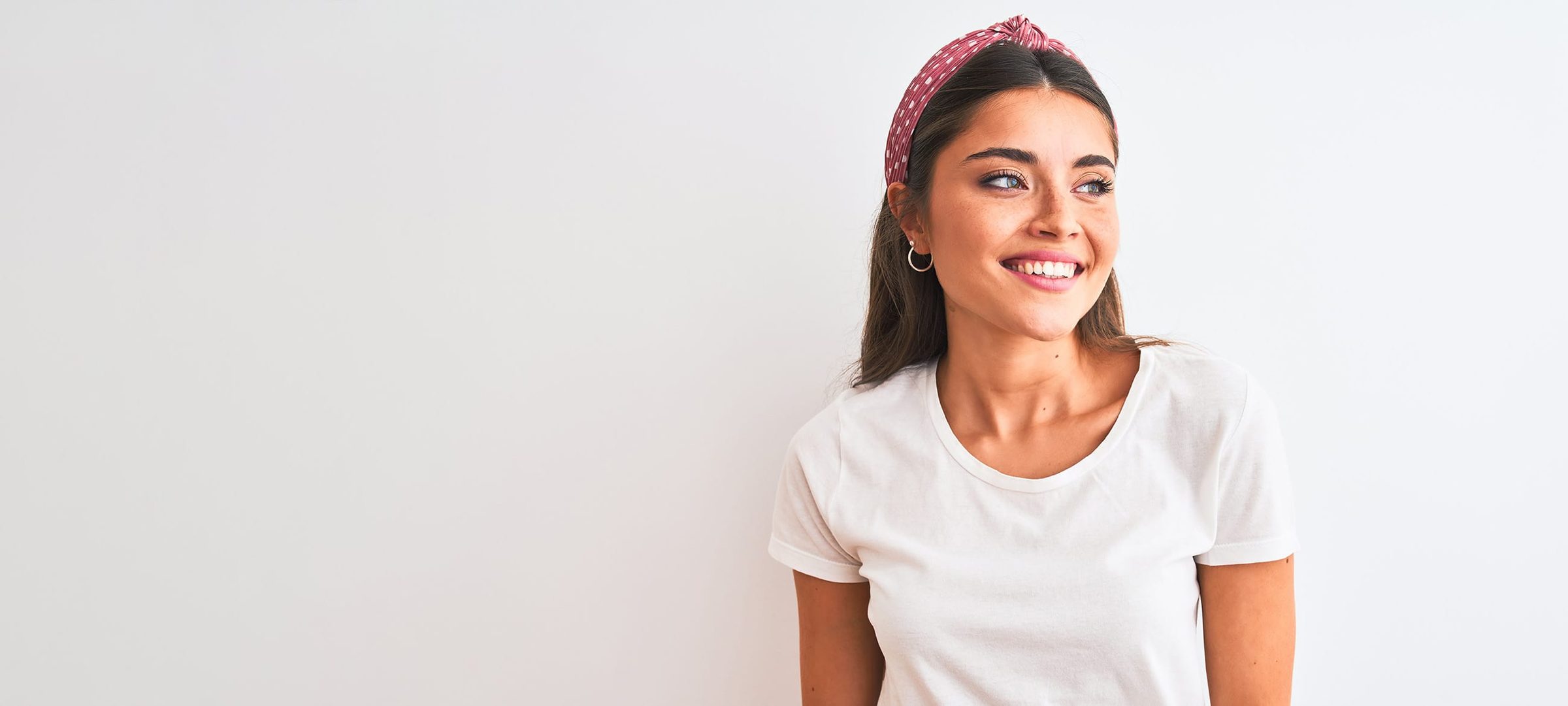 Woman in a white shirt and red headband