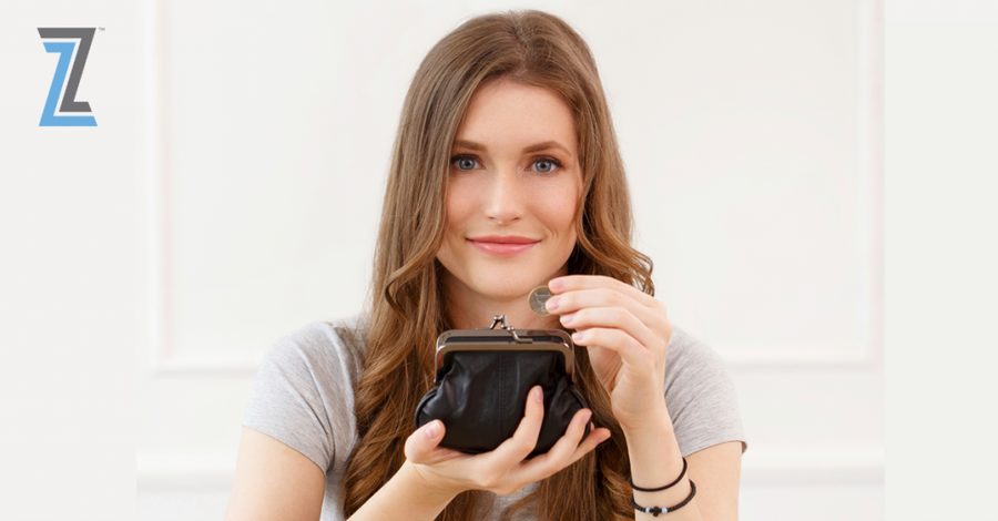 Smiling woman holding a coin purse and a coin, representing the cost of breast augmentation
