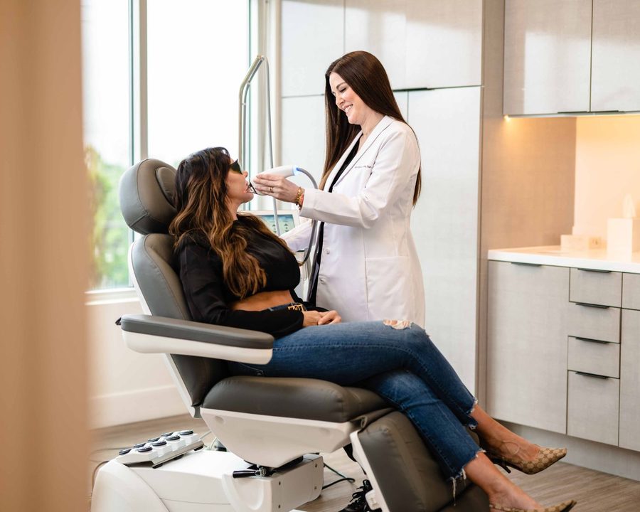Laser technician performing a MOXI treatment on a patient at The Piazza Center